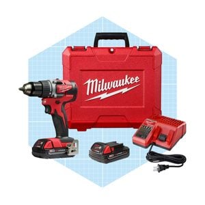 A red cordless drill set includes a drill, two batteries, a charger, and a hard case, all on a light blue grid background.